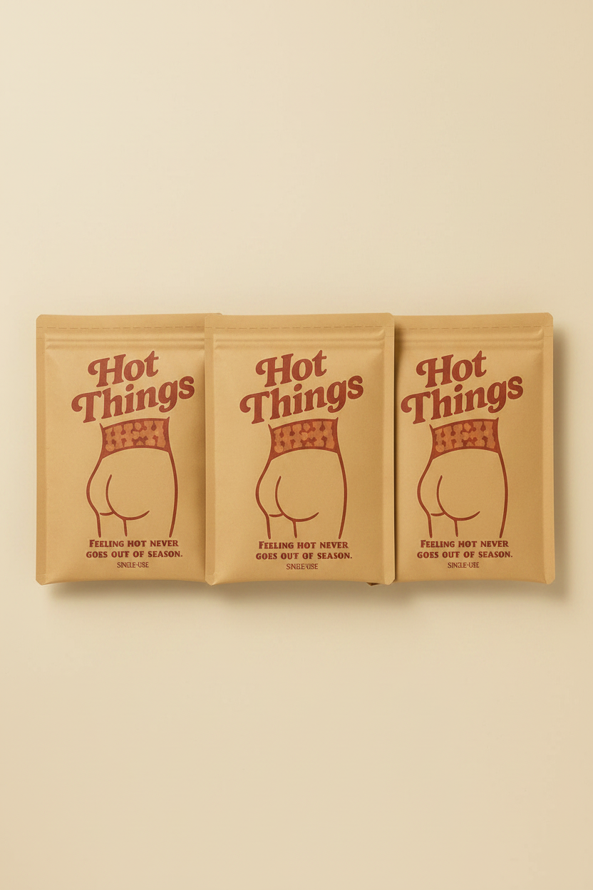 Three packages of 'Hot Things' on a beige background