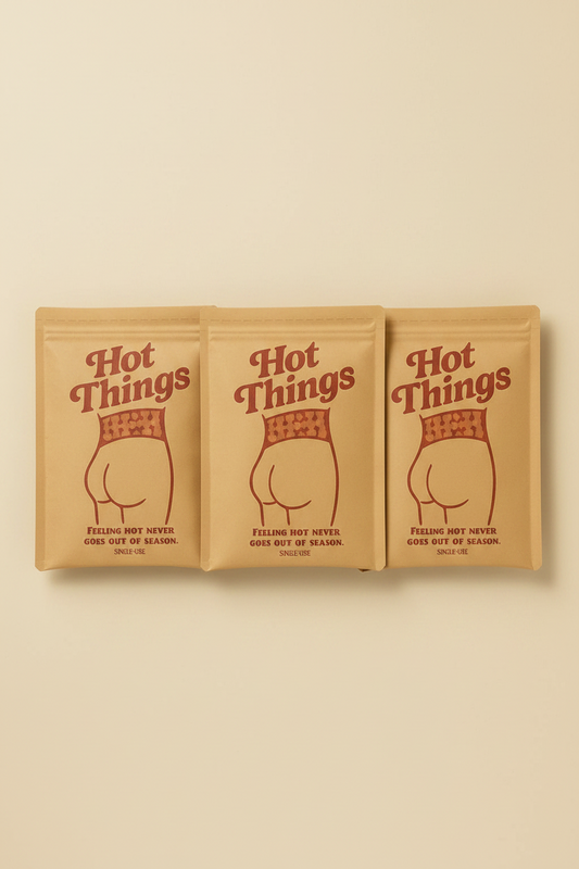 Three packages of 'Hot Things' on a beige background